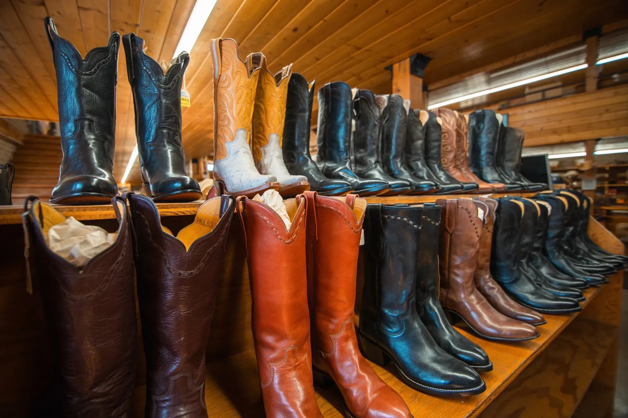 Finished boots on a shelf in the Paul Bond store