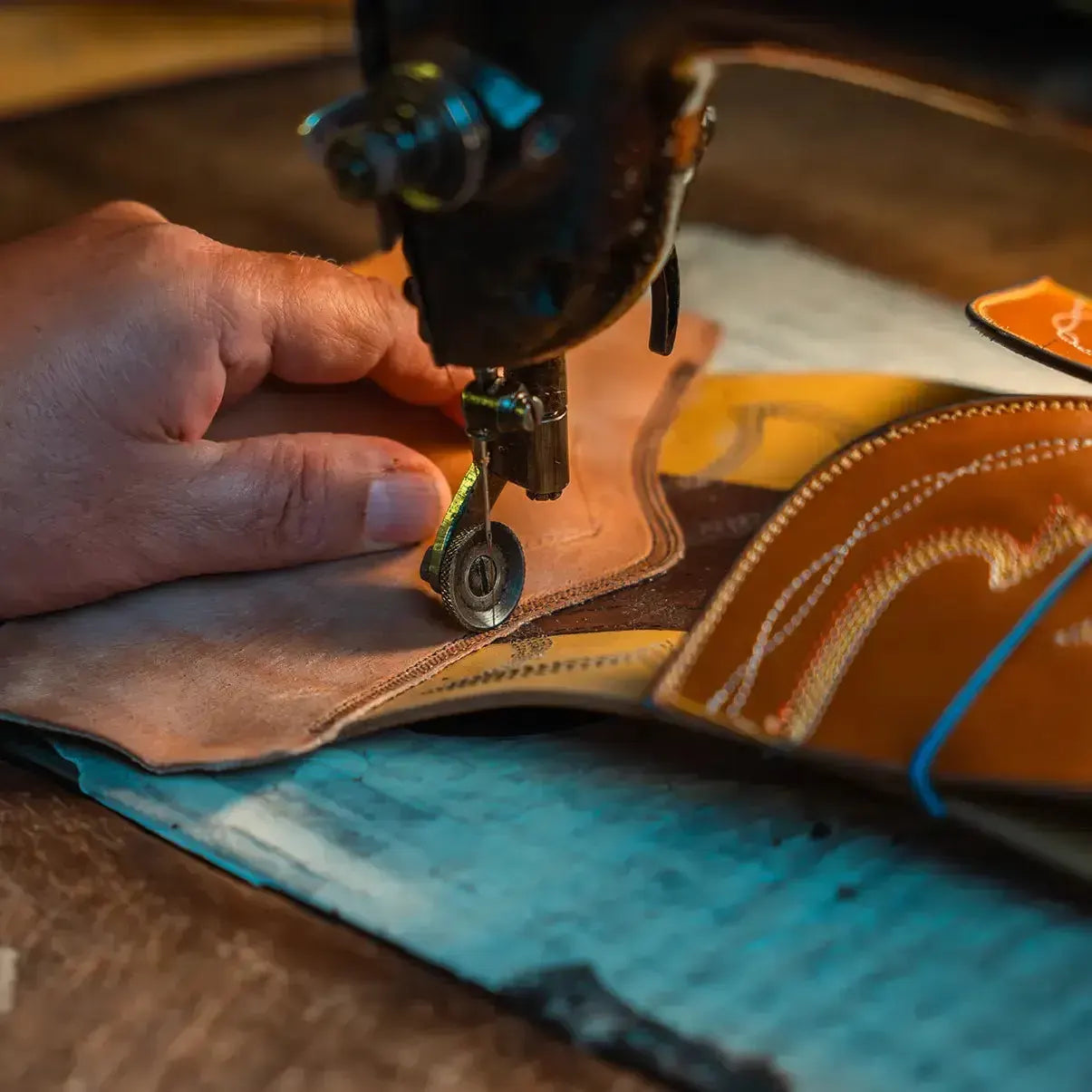 A bootmaker stitching a boot shaft