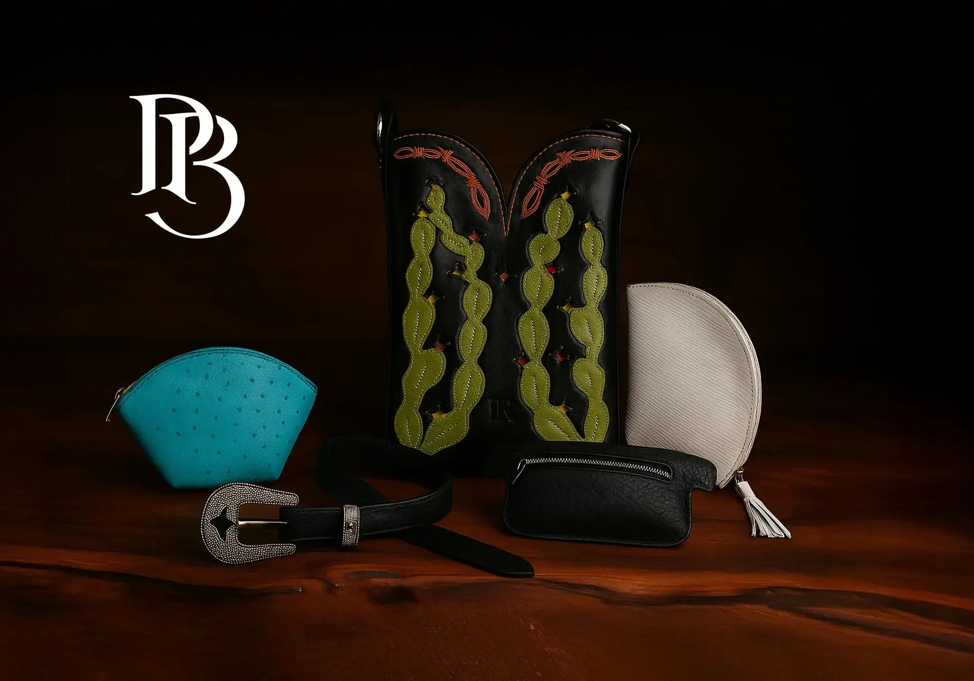 Paul Bond exotic leather purse and accessories on a dark table