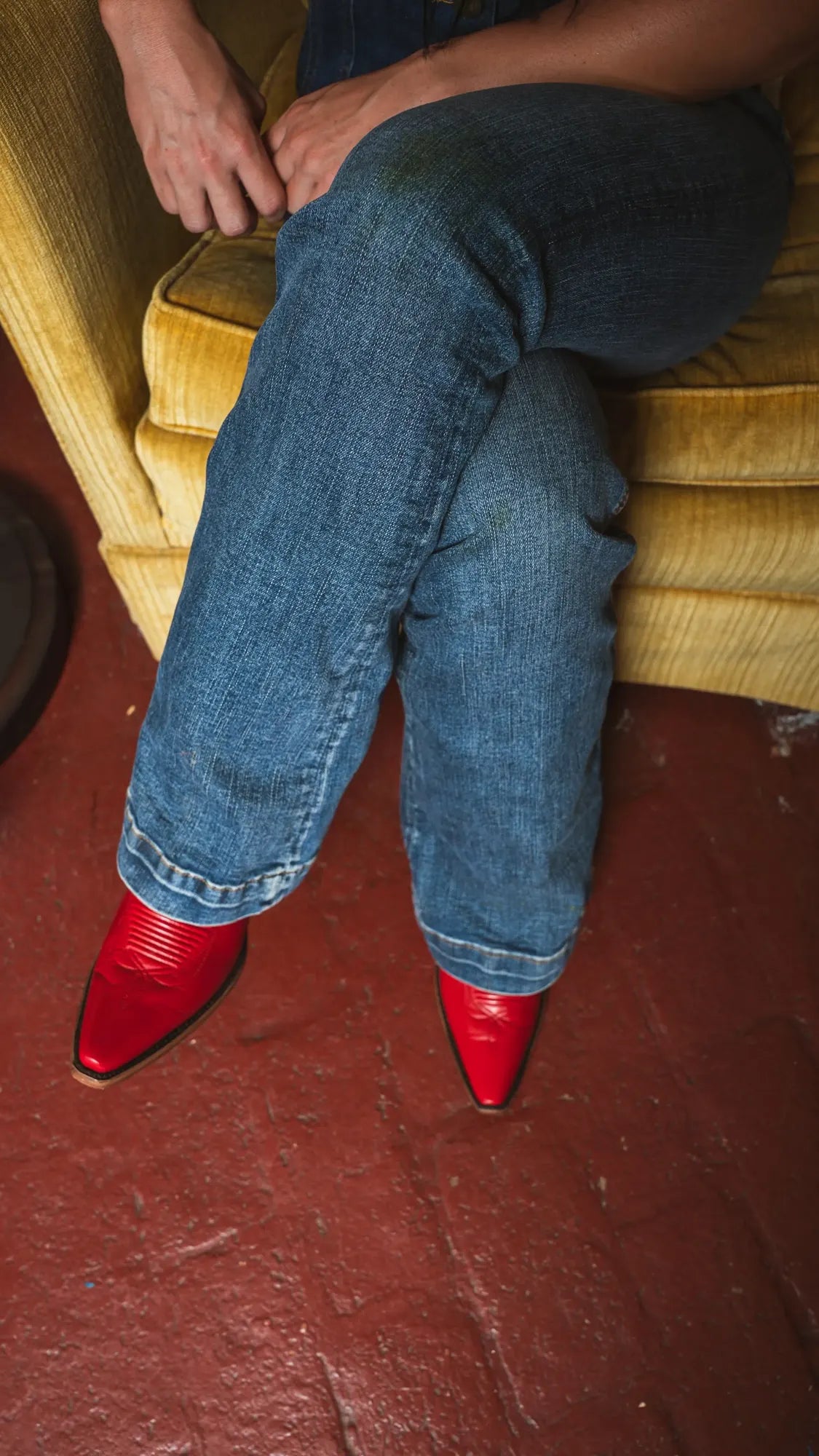 Red cowboy boots under bootcut jeans
