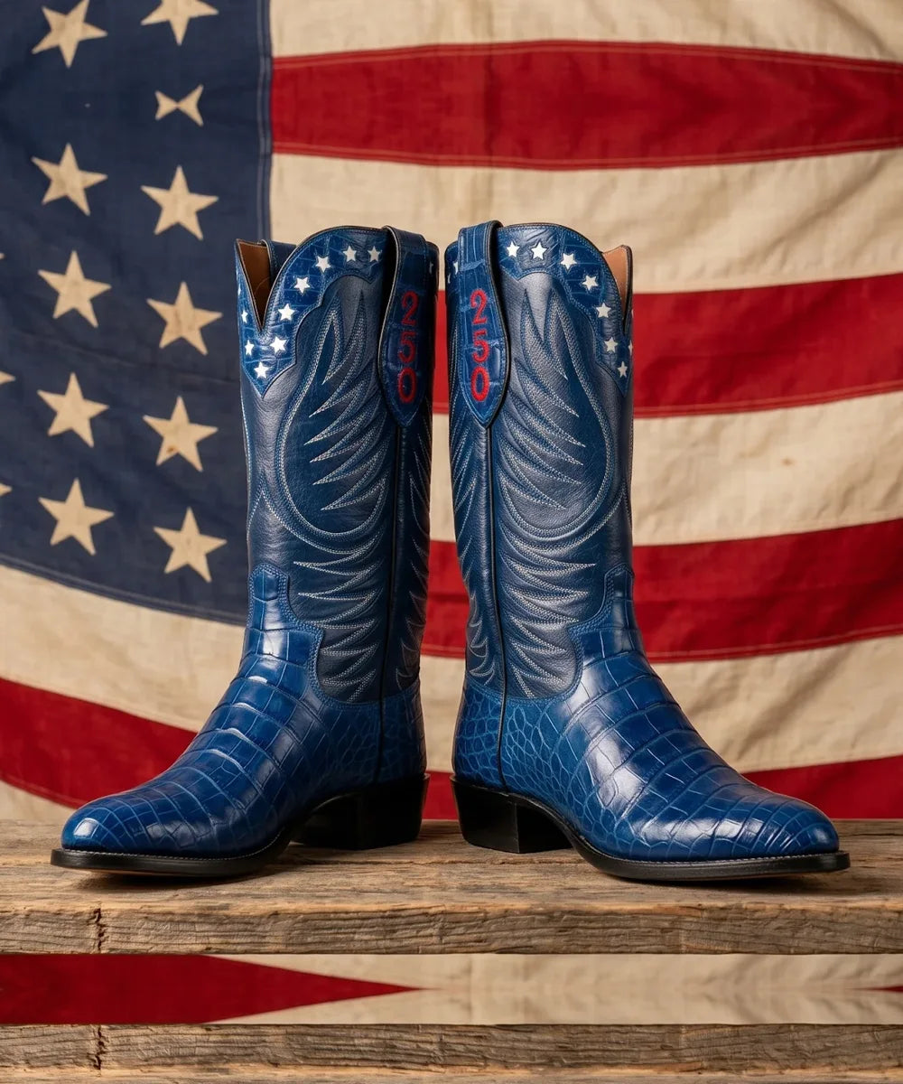 The Semiquincentennial boots in navy alligator in front of an American flag