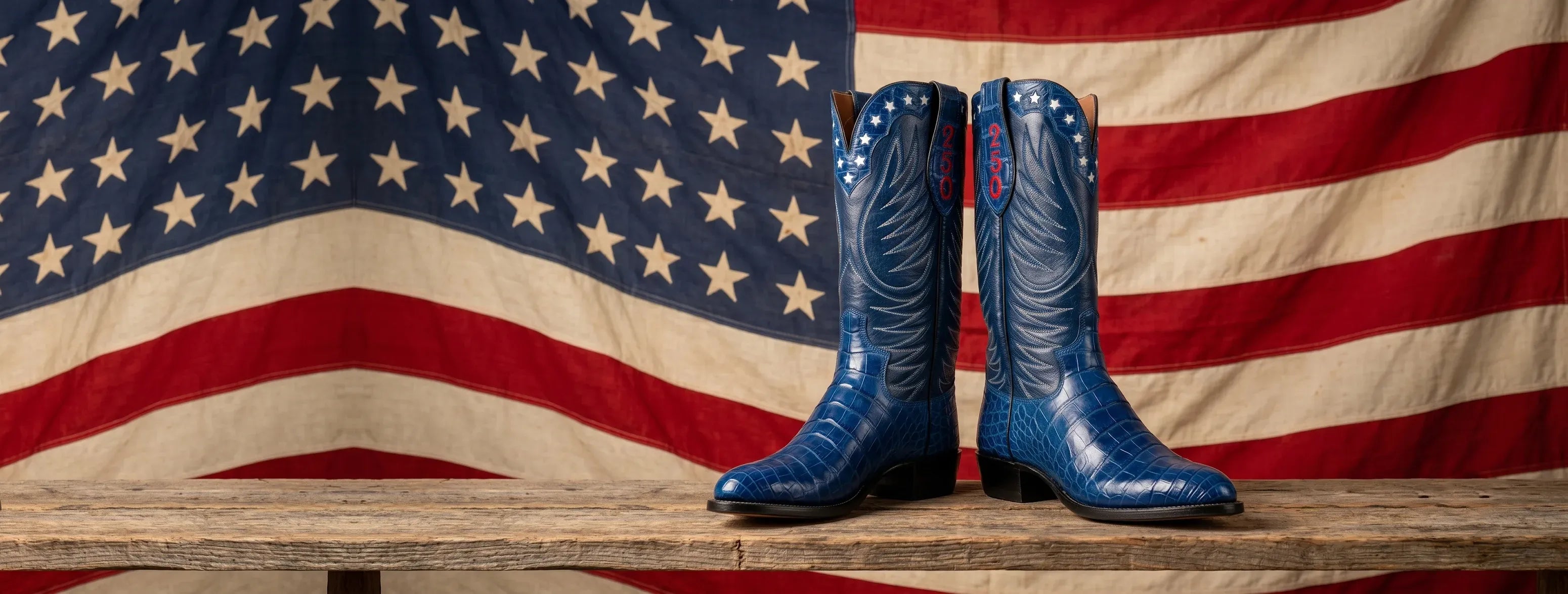 Navy alligator Semiquincentennial boots in front of an American flag